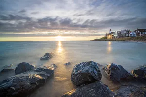 Sunset waves on rocky coastline nature travel background