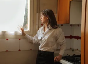 Happy woman smiling in stylish kitchen interior