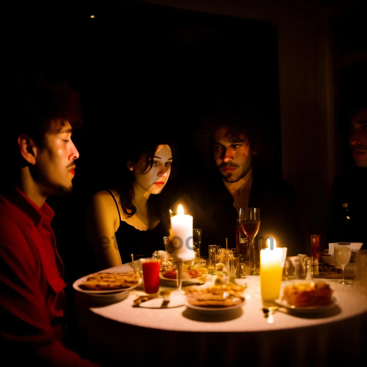 Picture of Elegant dinner celebration with wine and candles.