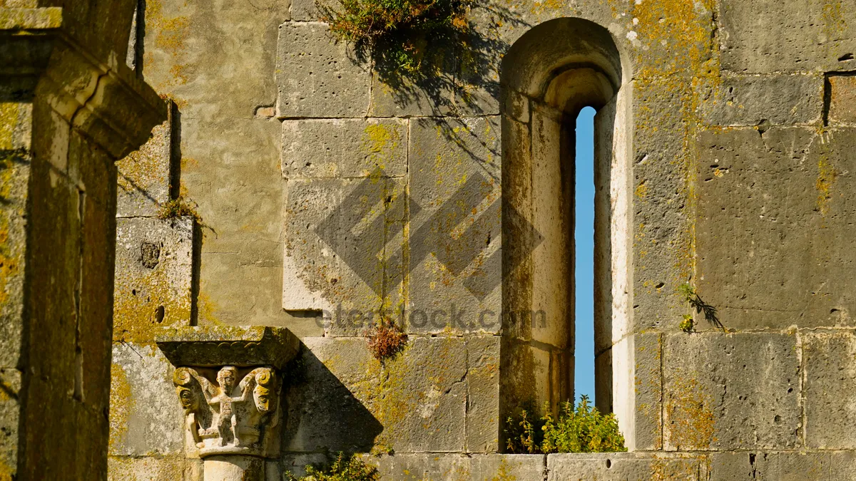 Picture of Medieval church window with ancient stone arch