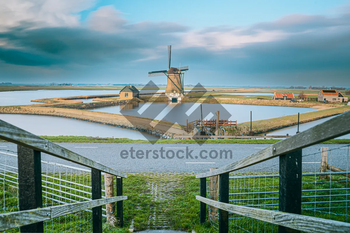 Picture of Suspension bridge over river in urban cityscape.