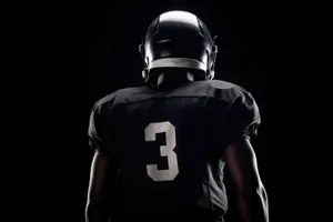 Male body in black football helmet covering head