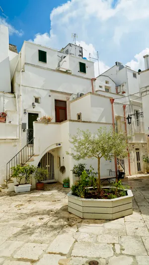 Old stone house with balcony and flowers