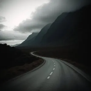 Scenic Mountain Drive under Cloud-Filled Sky