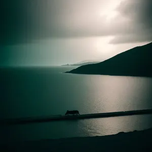 Tranquil Coastal Sunset with Silhouetted Fisherman