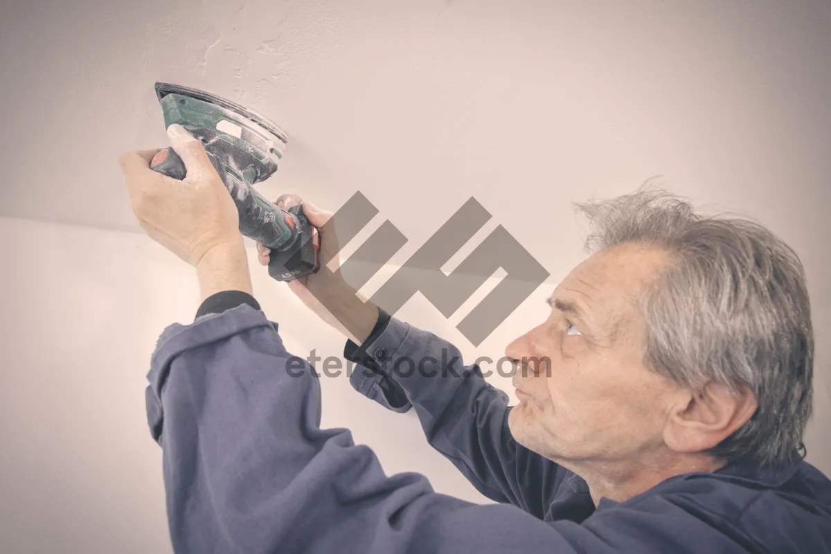 Picture of Happy male professional working on laptop at home office.