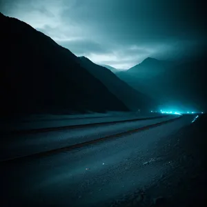 Scenic Sunset Drive: Asphalt Highway against Mountainous Sky