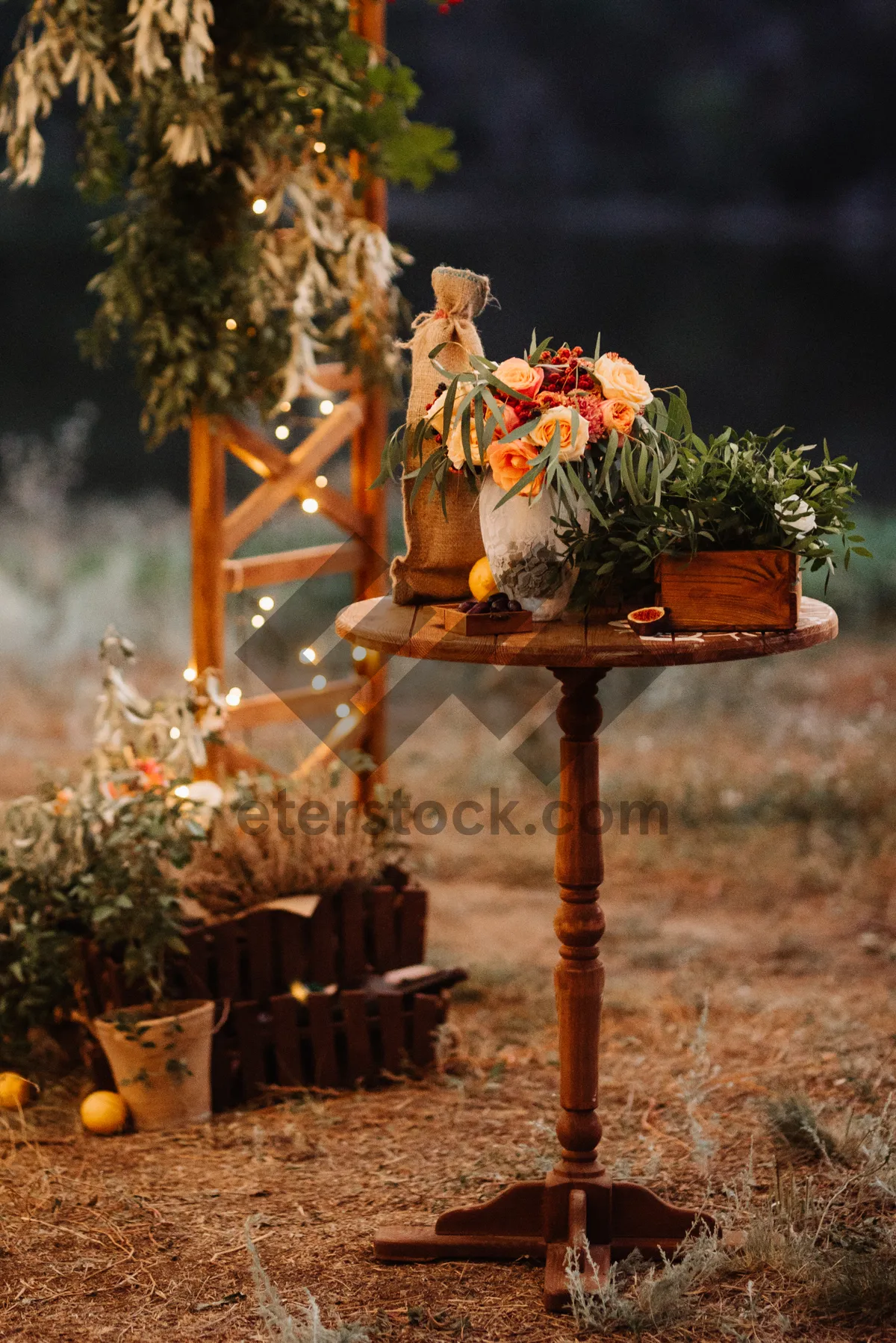 Picture of Bird feeder hanging on tree with colorful flowers.