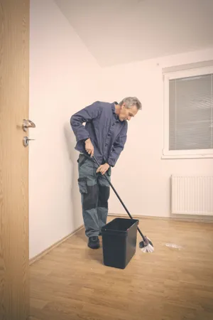 Male golfer cleaning golf club with swab.