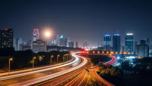 Cityscape with blurred car lights on highway at night.