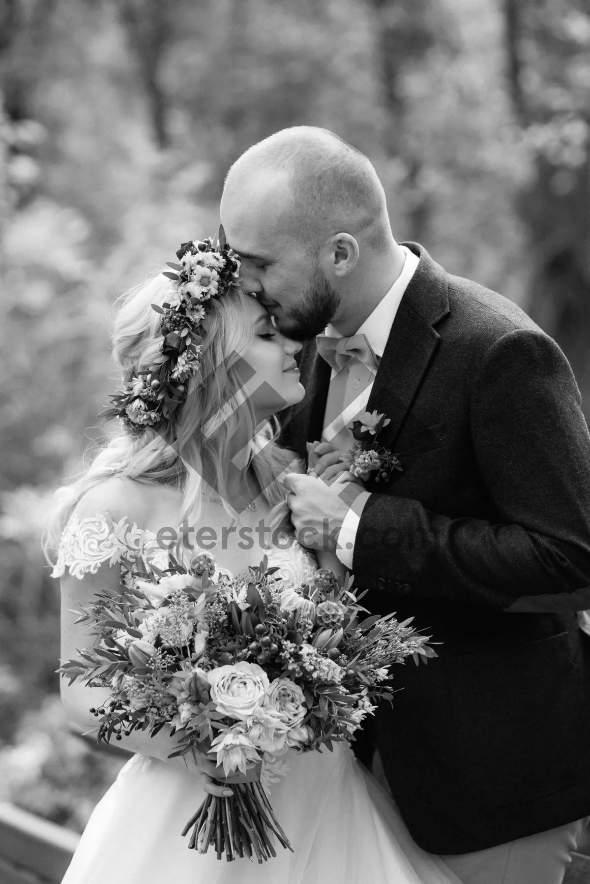 Picture of Happy Wedding Couple Outdoors Smiling with Flowers