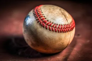 Baseball glove on grass field in team sport.