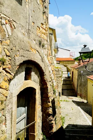 Historic Roman Fortress Wall with Arch and Monastery