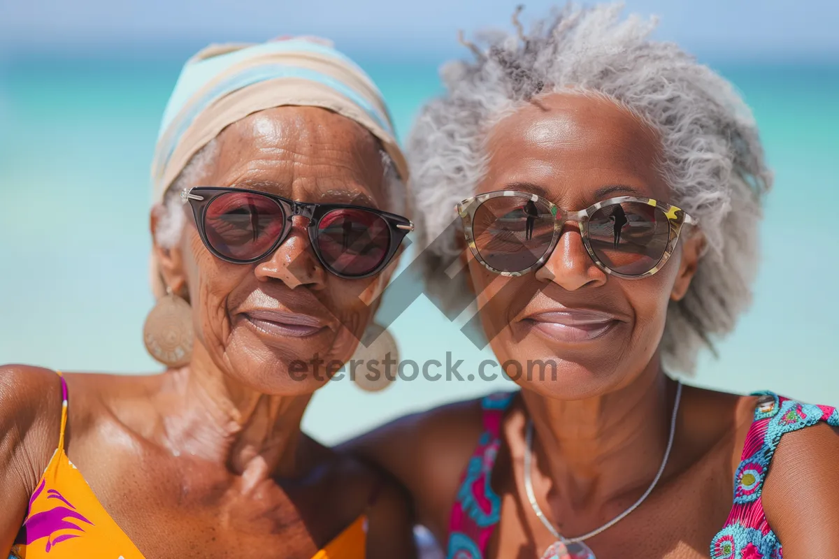 Picture of Happy couple in sunglasses enjoying beach vacation.