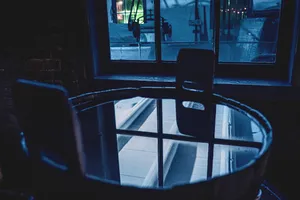 Modern interior room with table, chair, and window