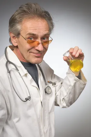 Smiling senior doctor in lab coat with stethoscope