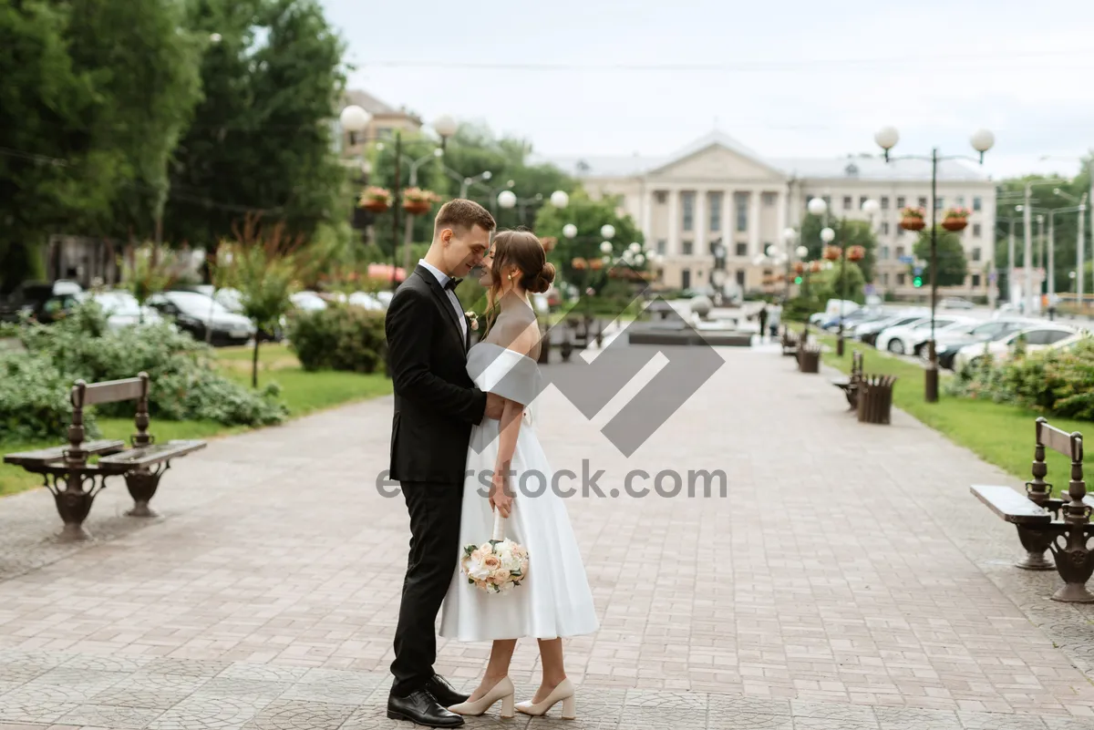 Picture of Happy groom and pretty bride smiling at wedding