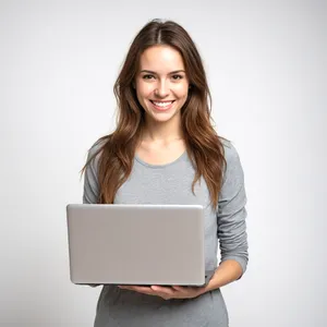 Attractive brunette businesswoman working on laptop in office.