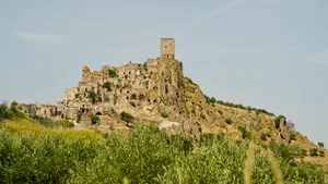 Ancient fortress on rocky hilltop against clear sky