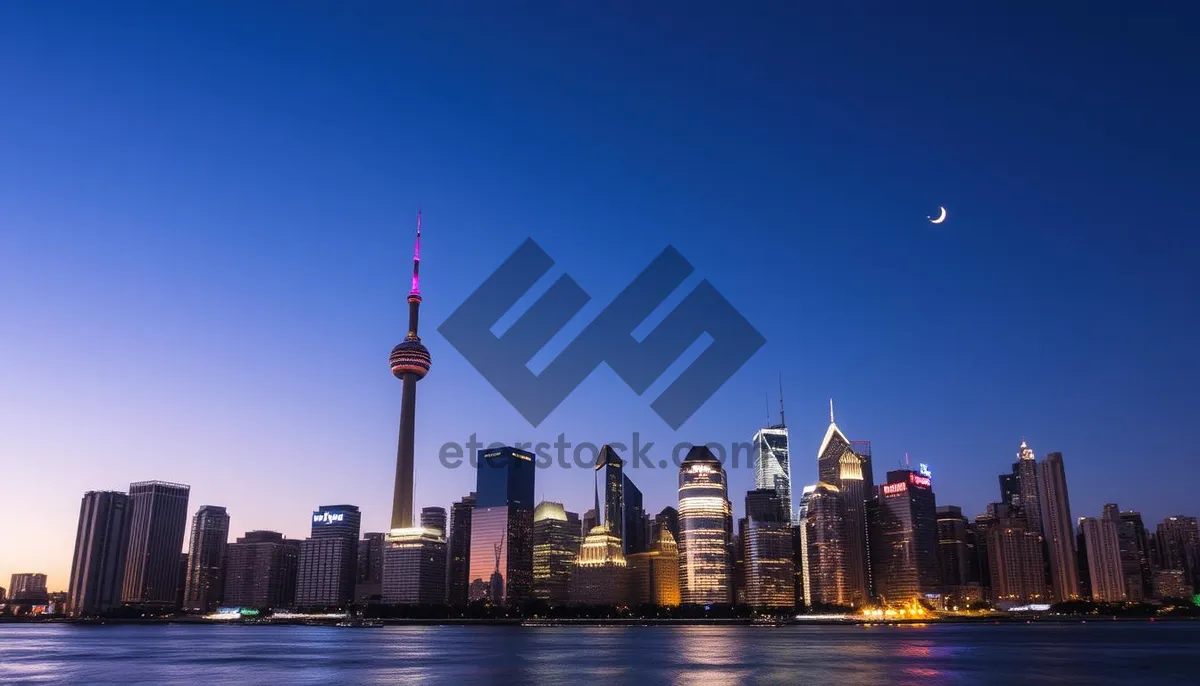 Picture of Modern business district skyline at night with river reflections.