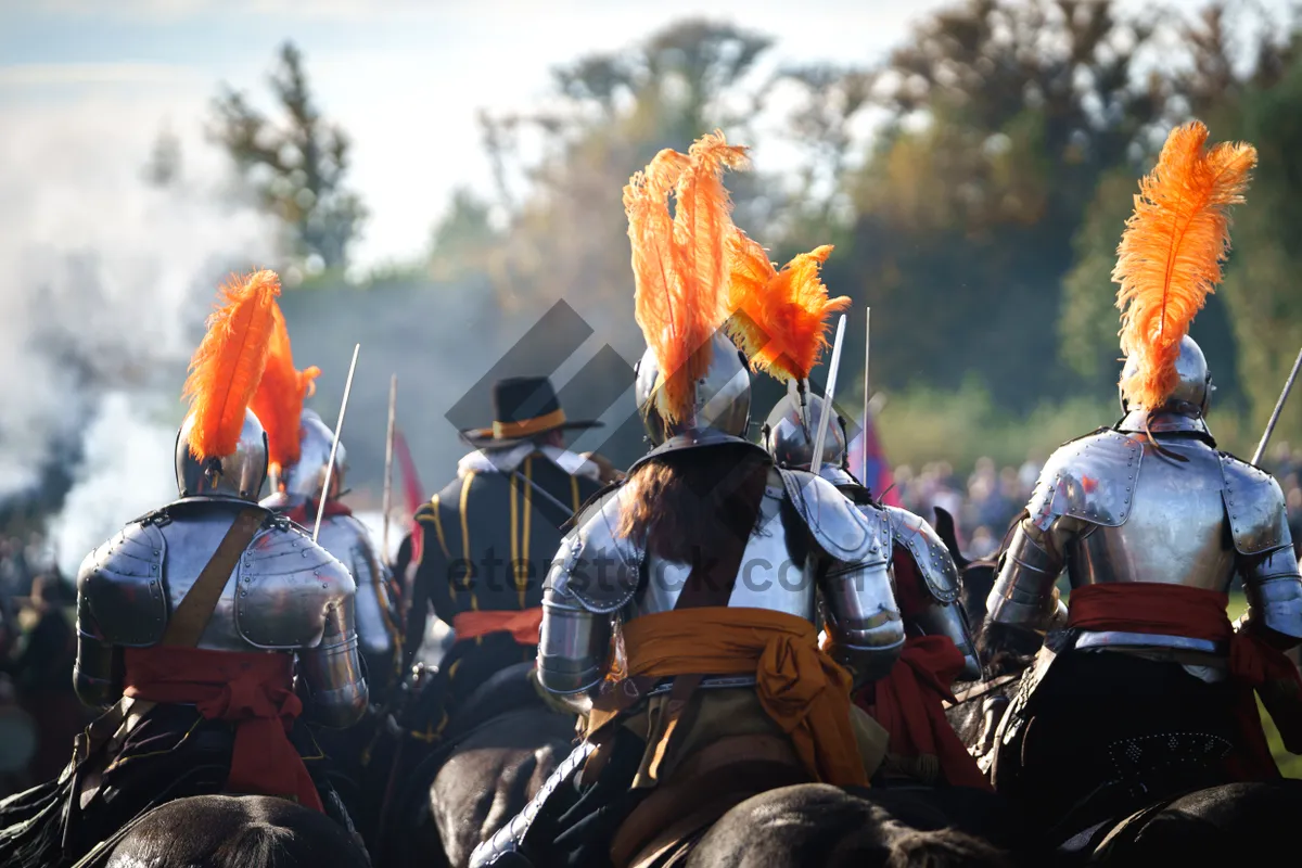 Picture of Male warrior holding a torch on horseback in battle