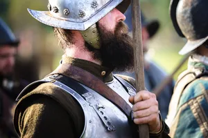 Male soldier in protective armor with gun