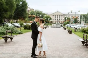 Happy groom and pretty bride smiling at wedding