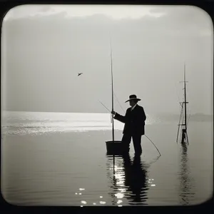 Silhouette of a fisherman enjoying sunset fishing