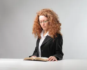 Attractive businesswoman sitting at office desk with laptop