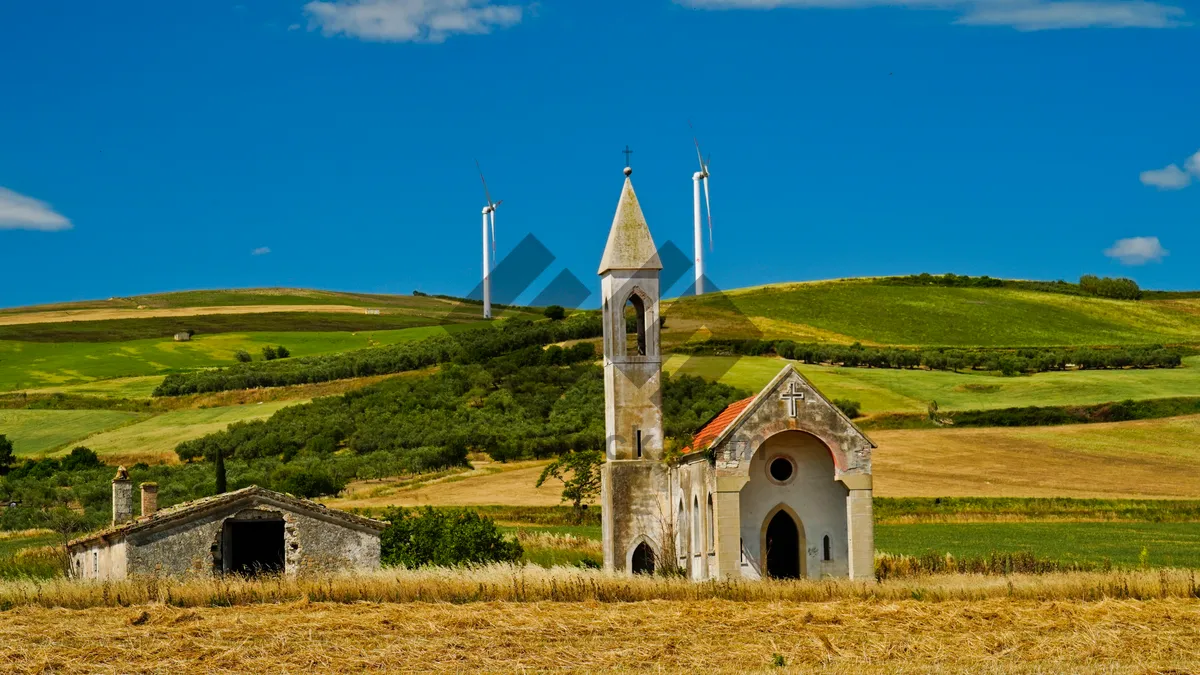 Picture of Ancient cathedral tower against blue sky.