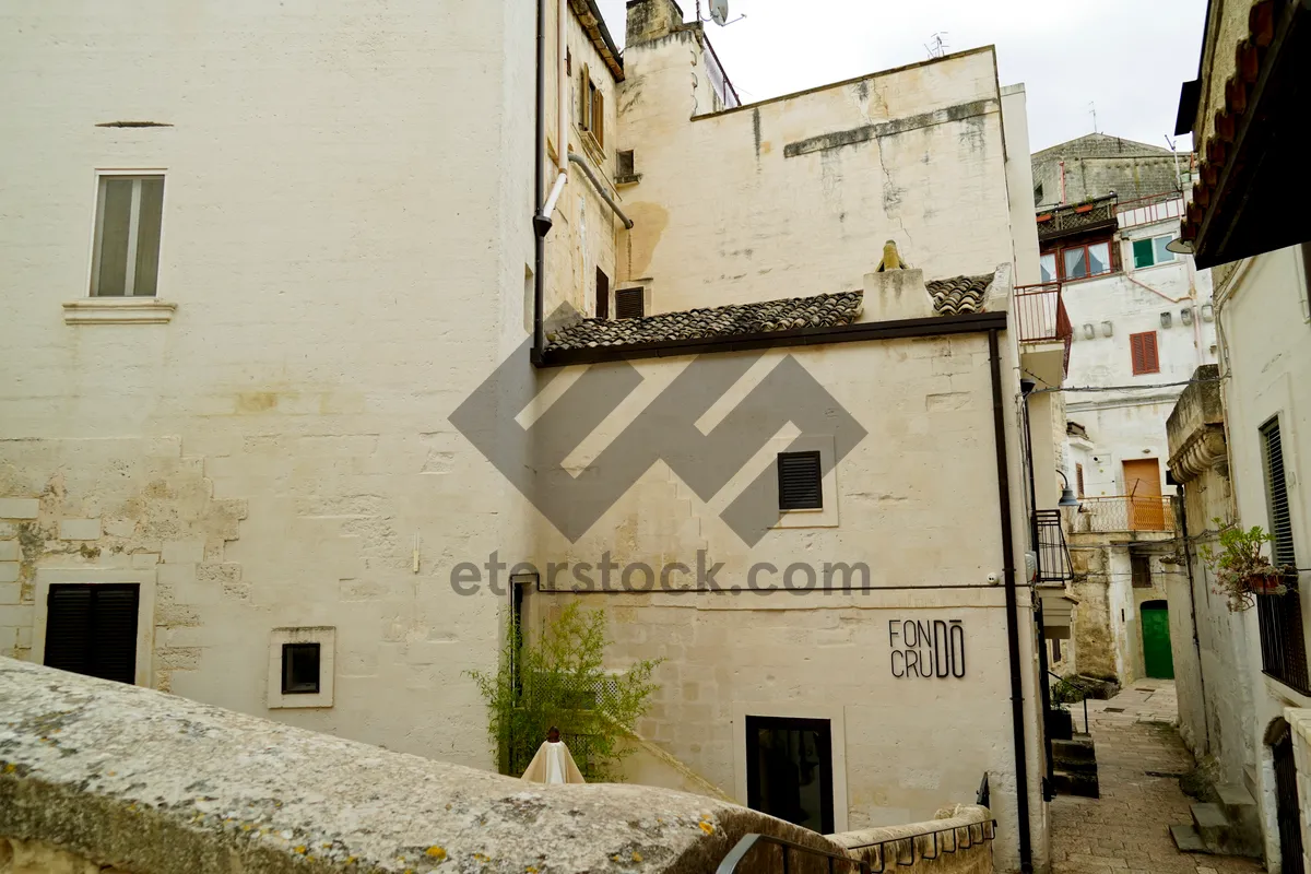 Picture of Medieval stone prison wall in ancient cityscape.