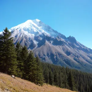 Snow-capped peak amidst stunning mountain range.