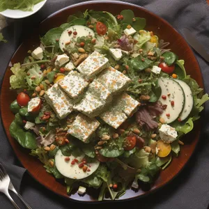 Healthy gourmet salad with fresh vegetables and sauce.