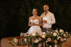 Happy couple outdoors on wedding day smiling together.