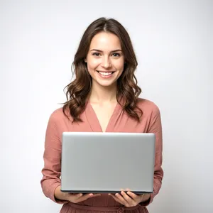 Happy businesswoman working on laptop in office.