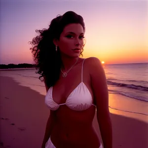 Attractive brunette model in sexy swimsuit on tropical beach.
