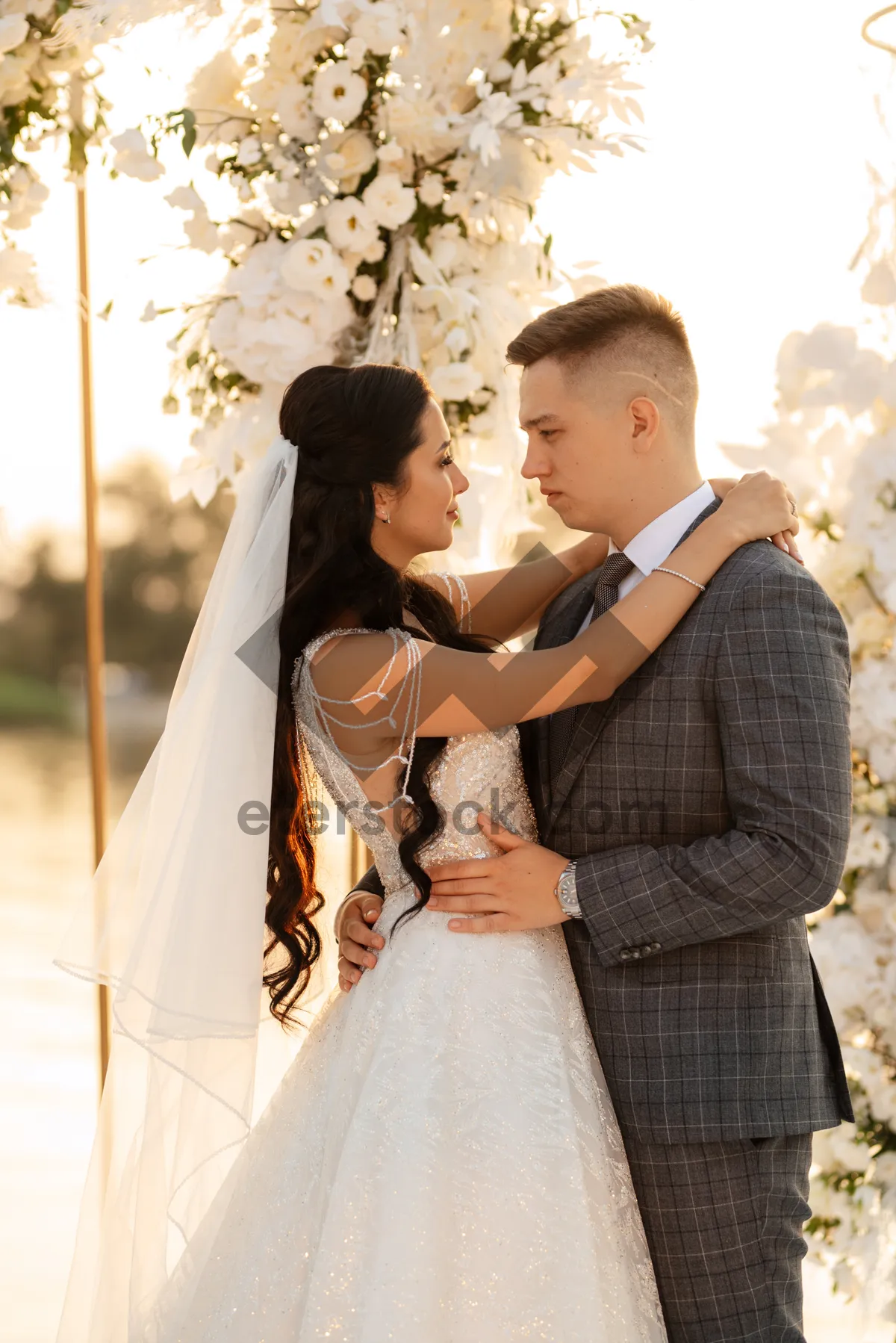 Picture of Happy bride and groom celebrating outdoors with flowers