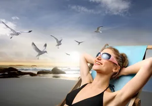 Smiling woman in bikini at tropical beach resort