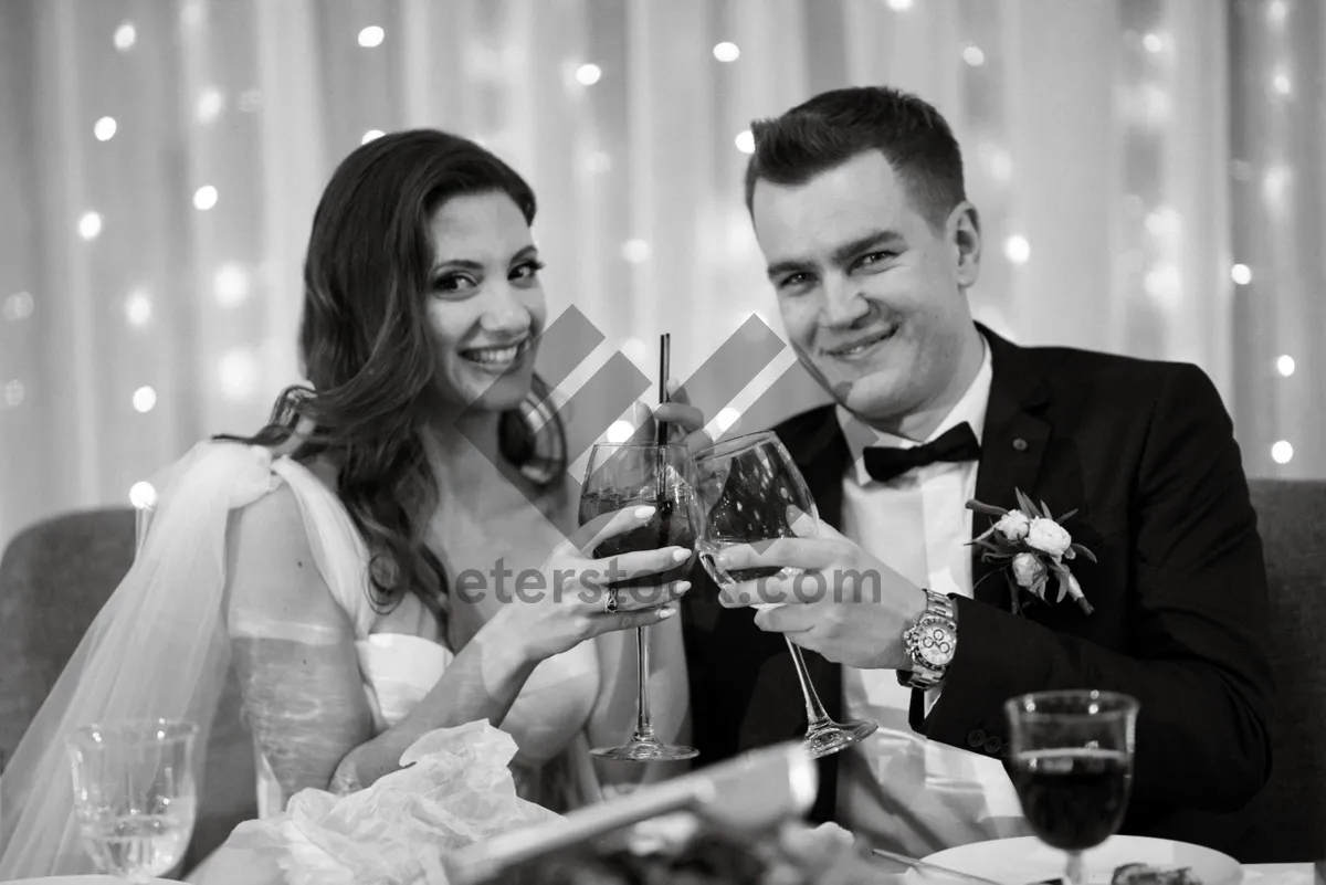 Picture of Happy groom celebrating with friends by drinking beer.