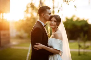 Happy newlywed couple smiling in the park portrait.