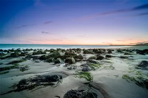 Tropical beach sunset over the ocean waves.