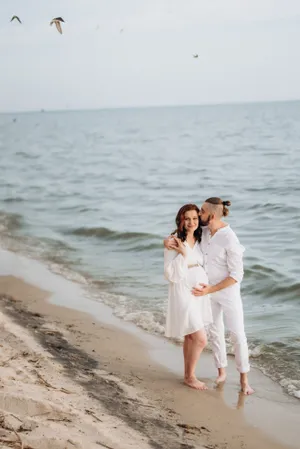 Happy couple enjoying beach vacation under blue sky