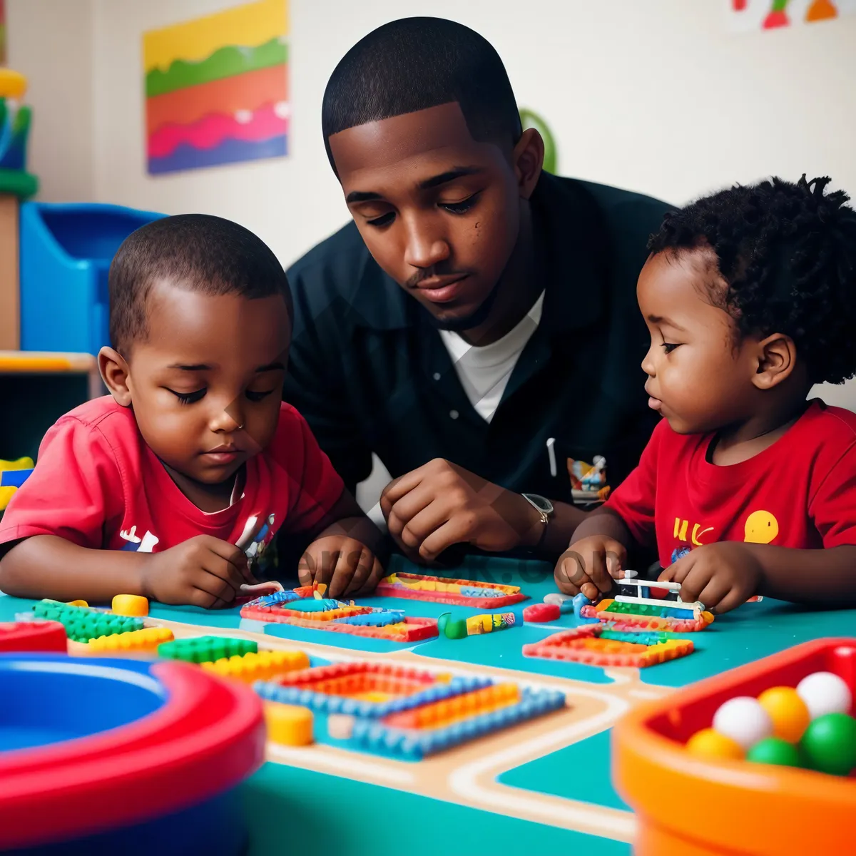 Picture of Joyful siblings learning together in preschool classroom