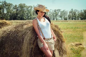 Happy Woman in Wheat Field on a Summer Day