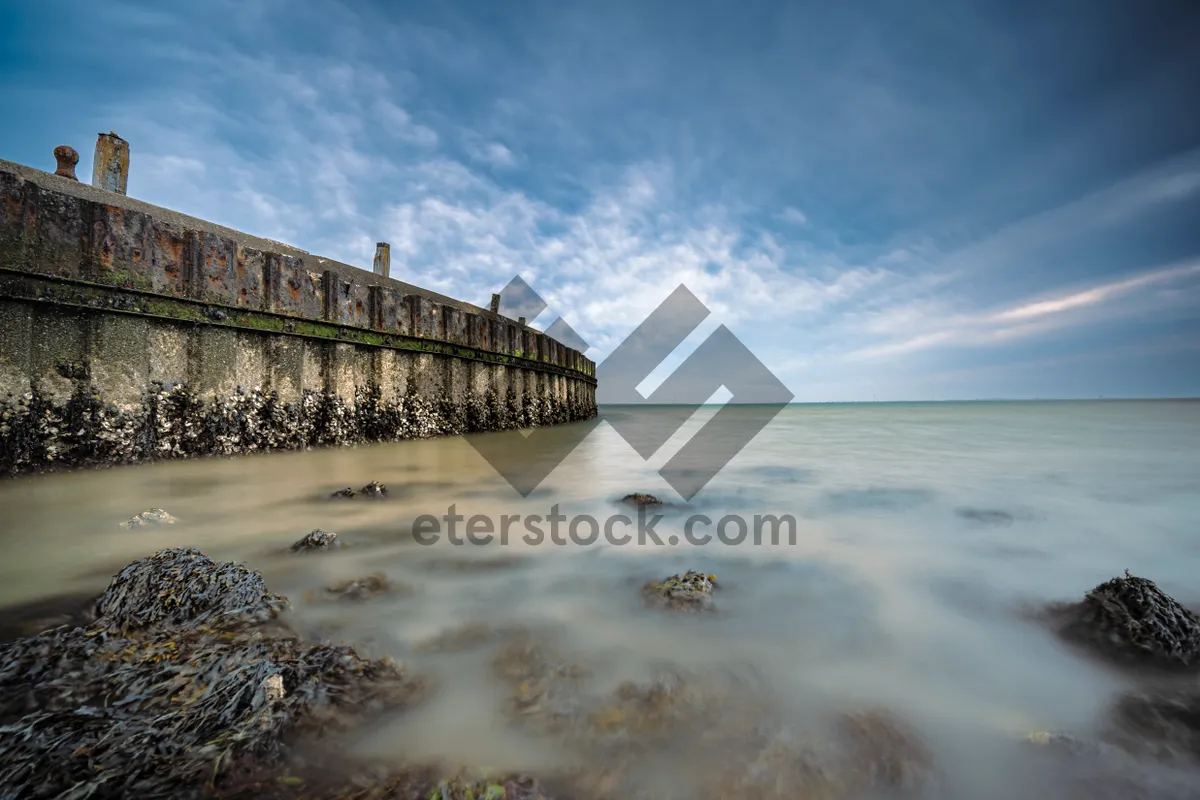 Picture of Tropical beach paradise with pier and clear skies.