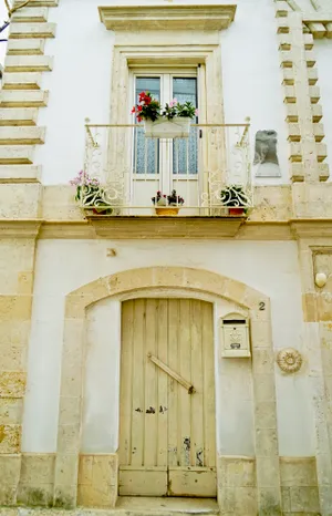 Historic stone church in old city with arched entrance.