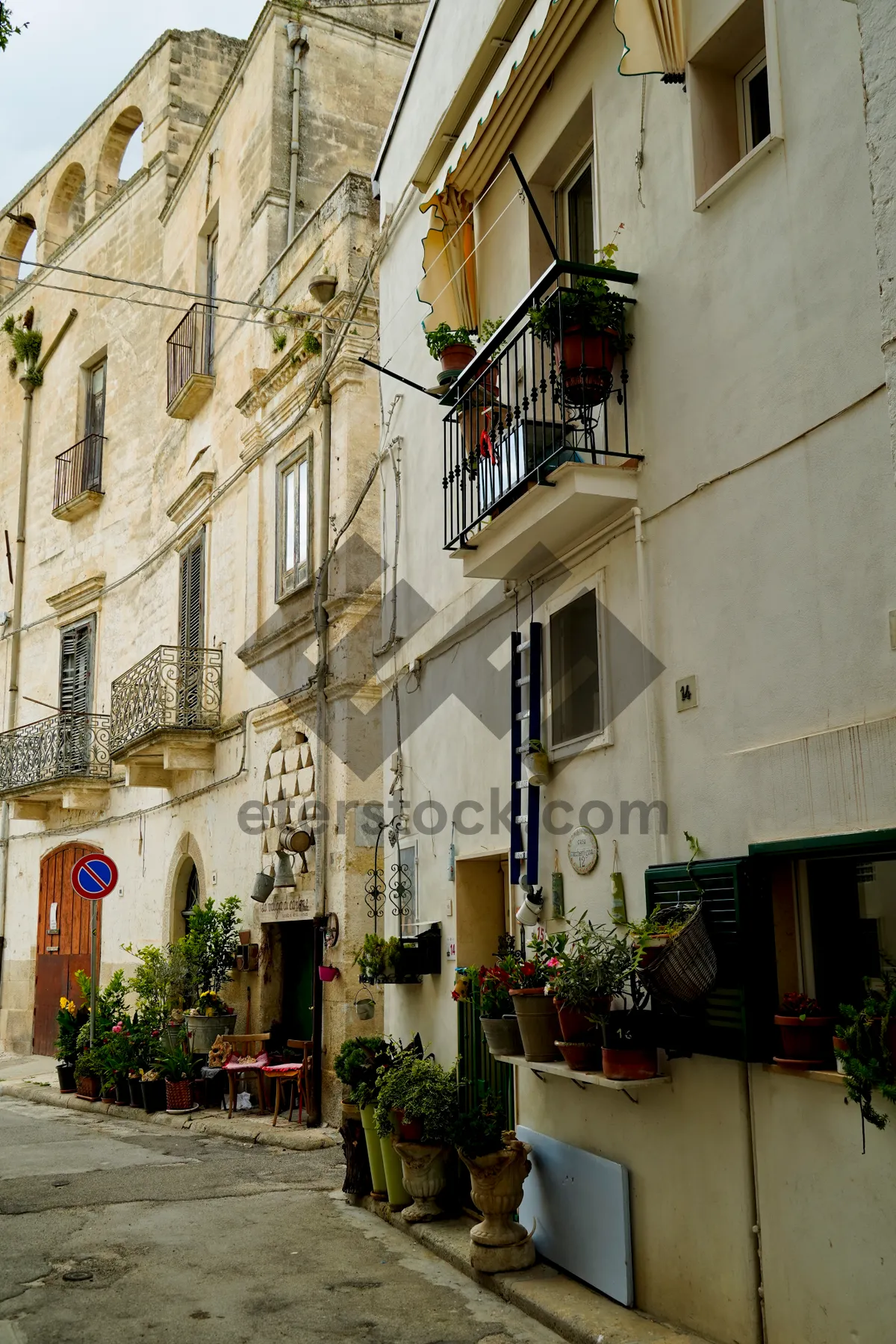 Picture of Old stone building with balcony in ancient city street.