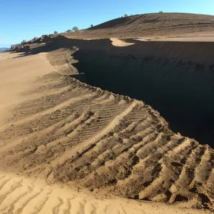 Dune Adventure: Majestic Sand Landscape Amidst Mountain and Sky