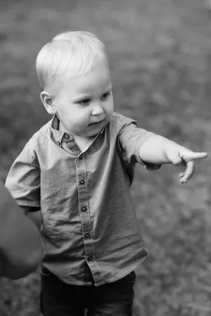 Happy blonde boy smiling in the park.