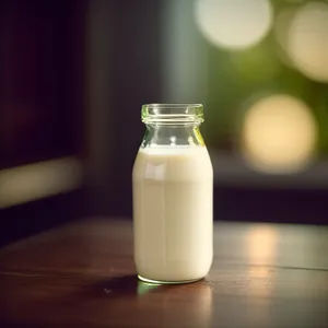 Delicious Dairy Drink in Glass Bottle with Saltshaker"
or
"Refreshing Milk Beverage in Glass Bottle with Saltshaker